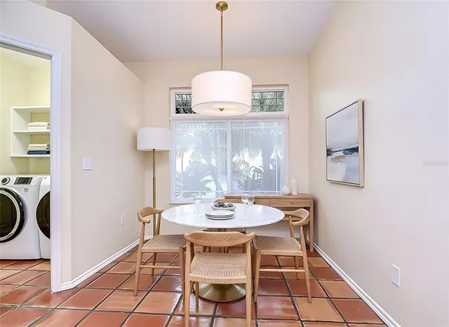a dining room with furniture and window