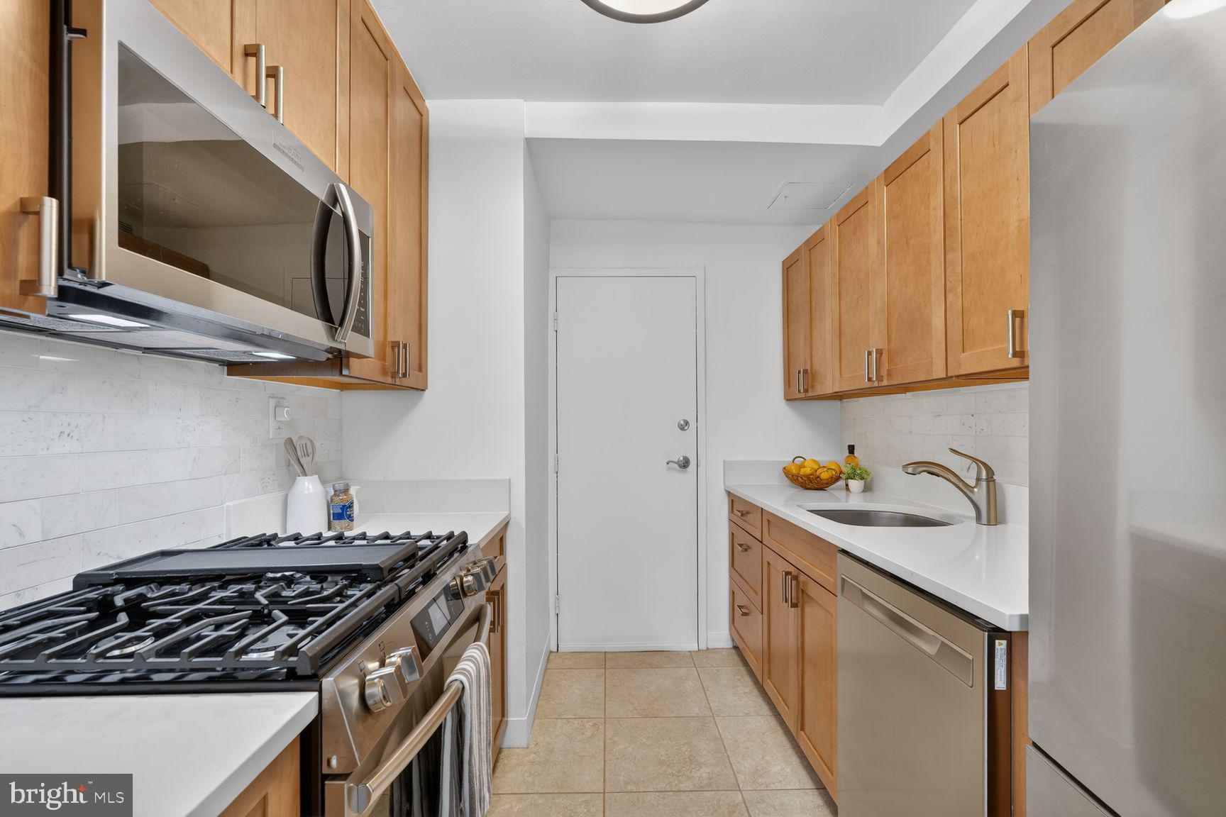 3900 Tunlaw Road Northwest, Unit 206 Washington, DC 20007 - Photo 6 of 28 Galley Kitchen with quartz counters