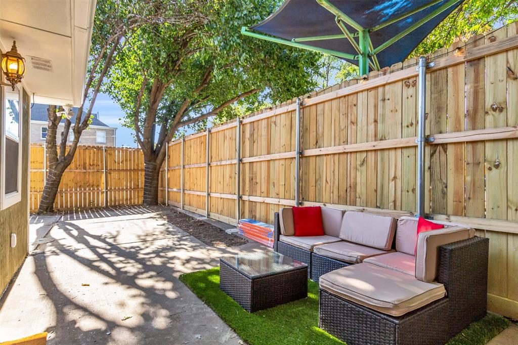 4121 Junius Street, Unit B Dallas, TX 75246 - Photo 3 of 32 Private outdoor patio featuring concrete and artificial turf surfaces