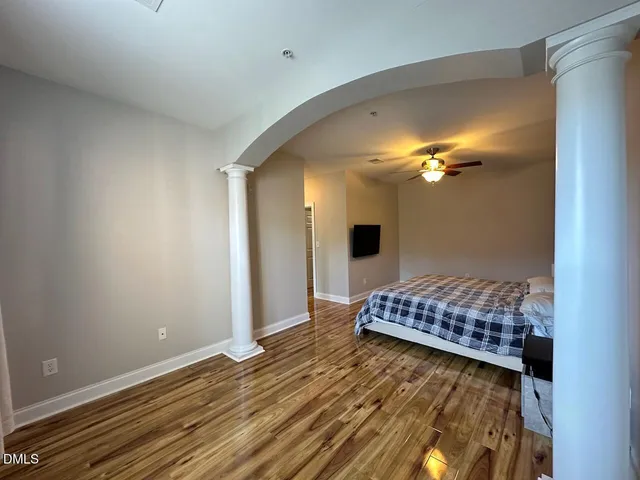 a bedroom with a bed and a chandelier