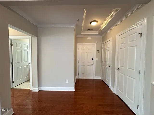 a view of a hallway with wooden floor