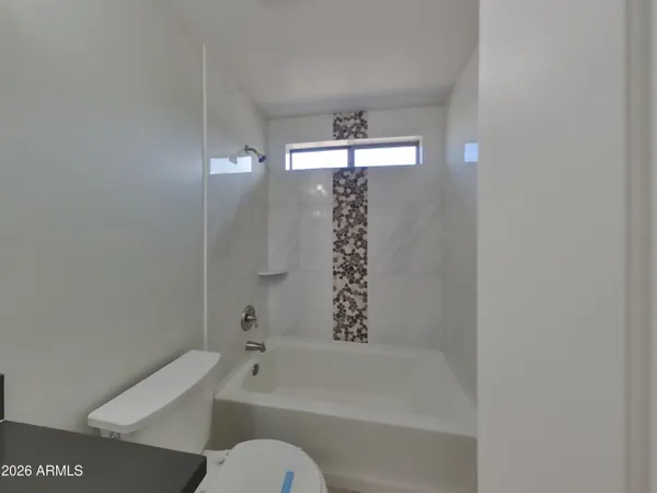 a bathroom with a bathtub a toilet and a shower