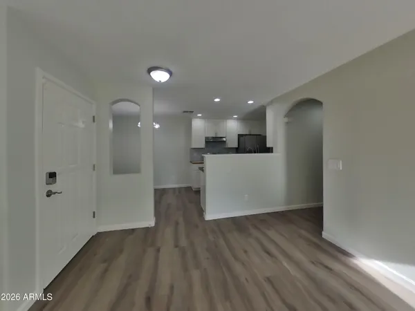 a view of a big room with wooden floor and windows