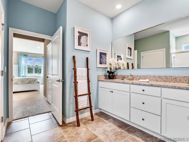 a spacious bathroom with a granite countertop sink mirror and toilet