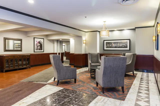 a living room with furniture and paintings on the wall