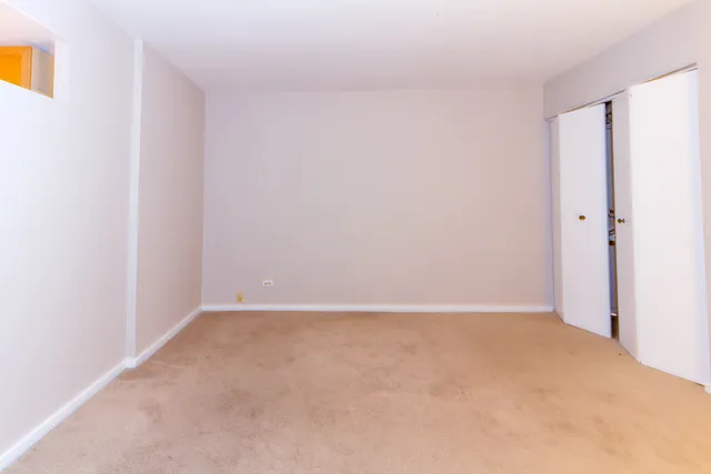a view of an empty room and a window
