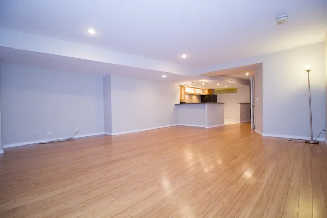 a view of kitchen with stainless steel appliances granite countertop a refrigerator and a sink