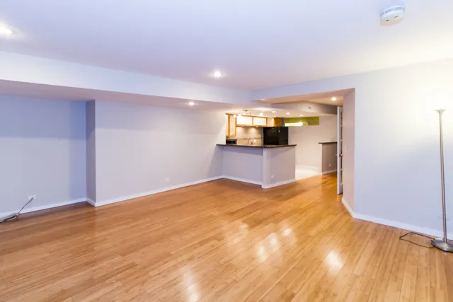a white kitchen with stainless steel appliances a sink and a refrigerator