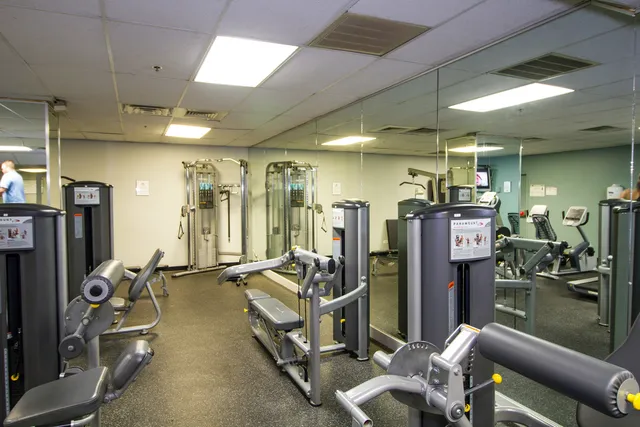 a kitchen with stainless steel appliances granite countertop a refrigerator and a stove