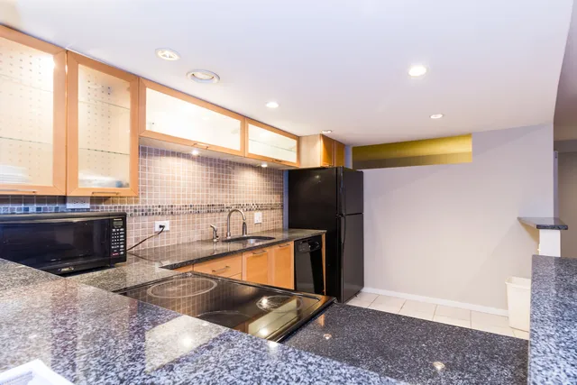 a kitchen with a refrigerator and a stove
