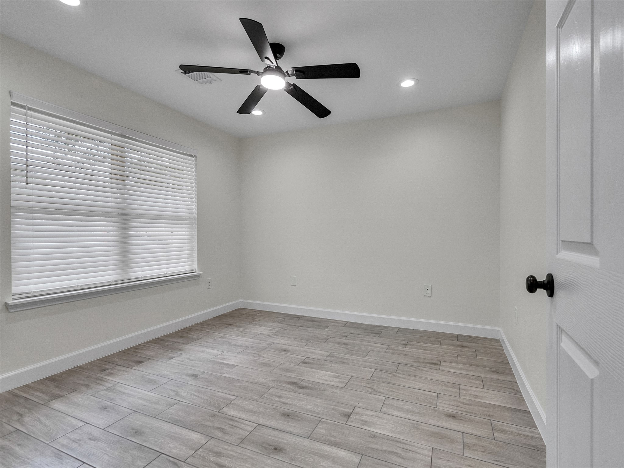 4835 County Road 380 Rosharon, TX 77583 - Photo 16 of 38 an empty room with wooden floor and windows