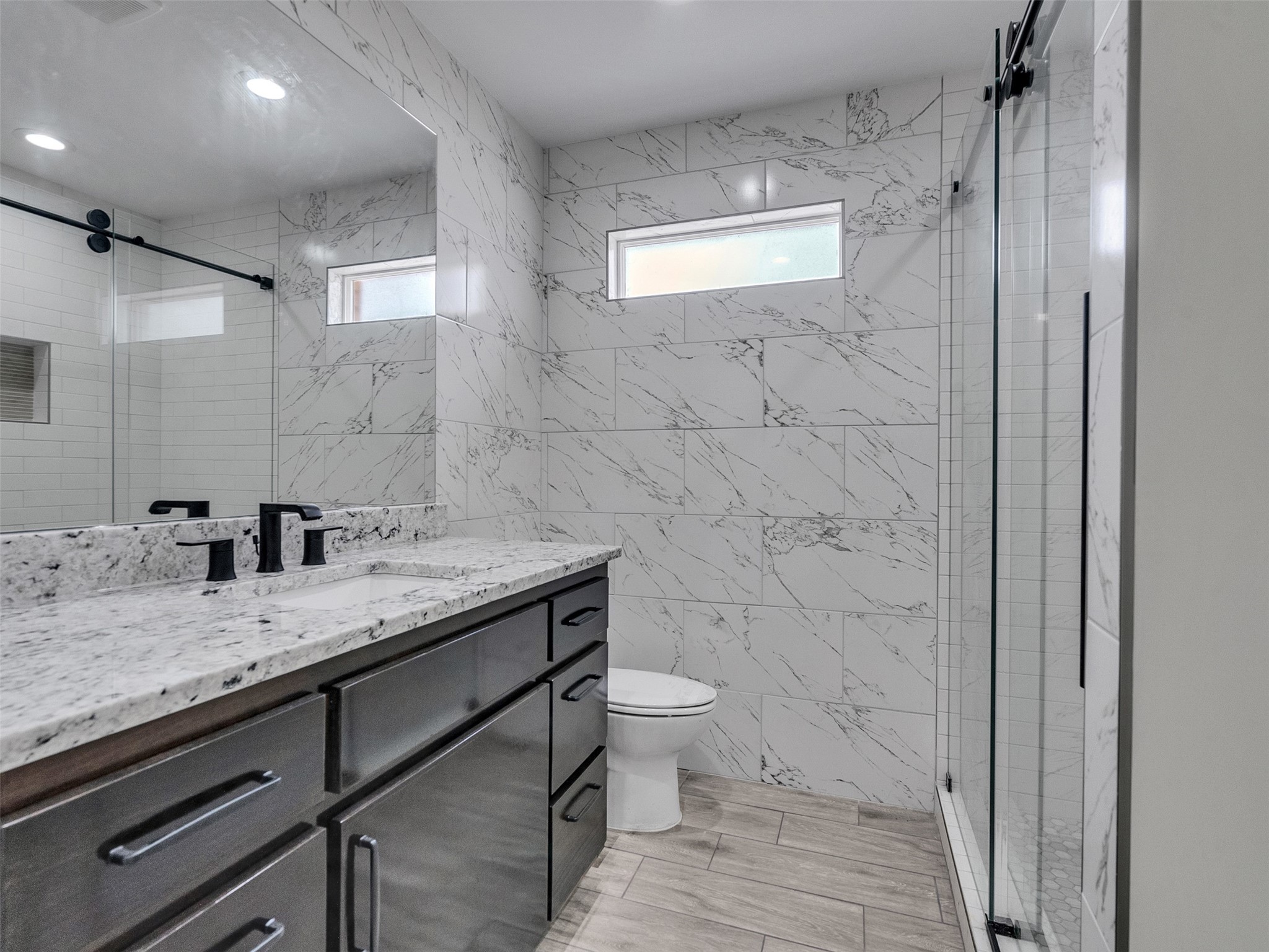 4835 County Road 380 Rosharon, TX 77583 - Photo 17 of 38 a bathroom with a granite countertop sink a toilet and a shower