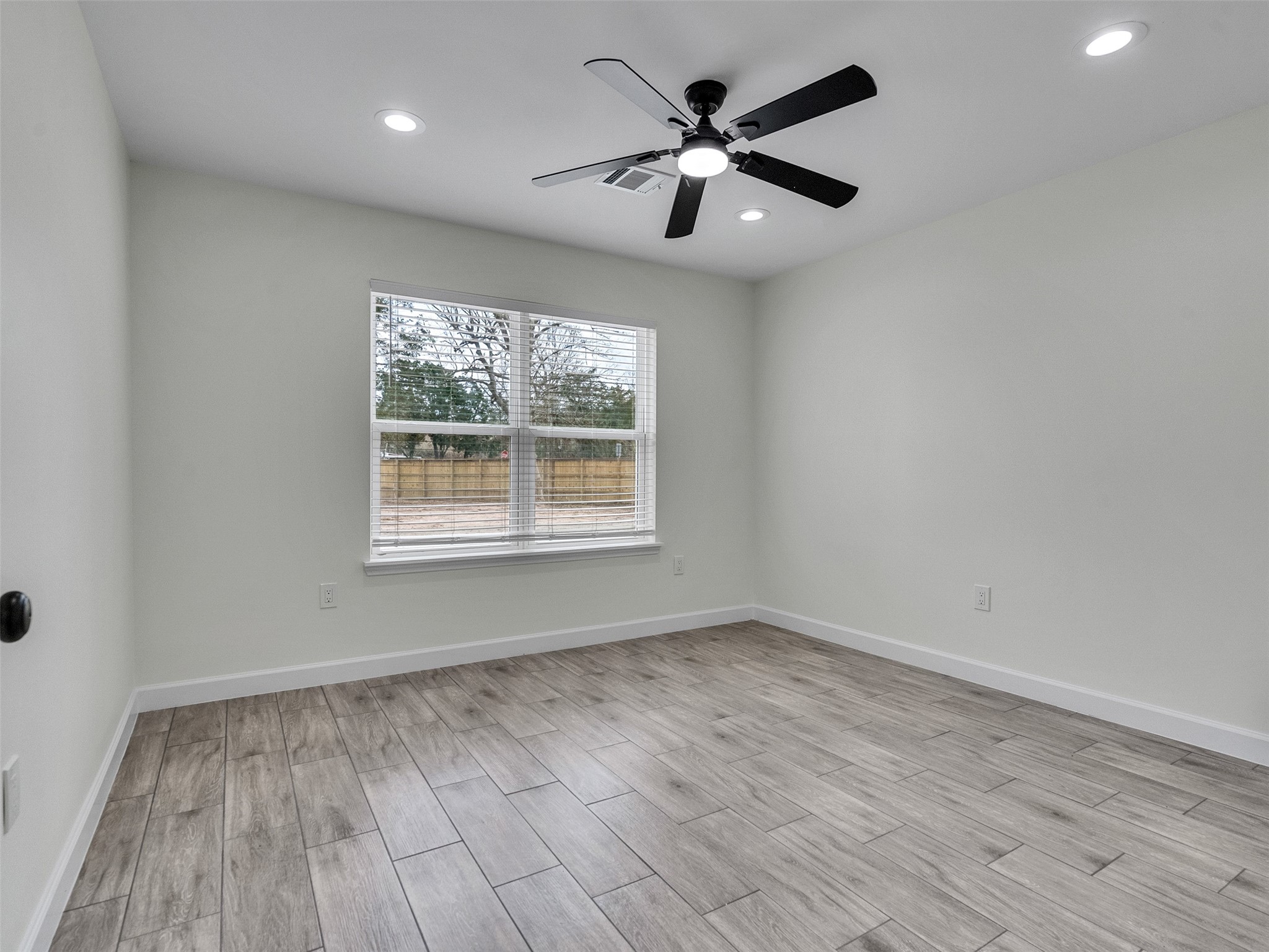 4835 County Road 380 Rosharon, TX 77583 - Photo 19 of 38 an empty room with wooden floor and windows