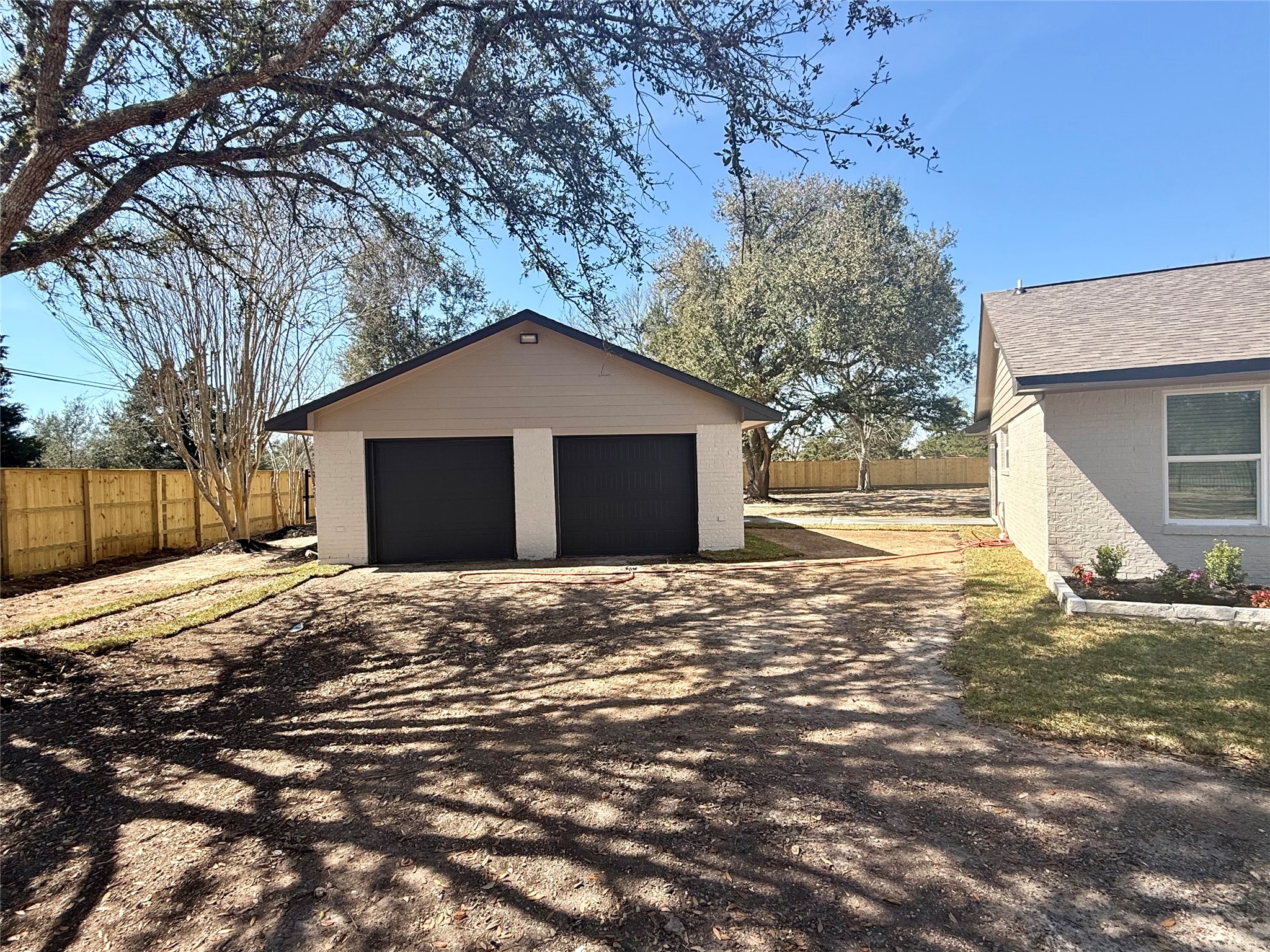 4835 County Road 380 Rosharon, TX 77583 - Photo 23 of 38 a front view of a house with a yard and garage