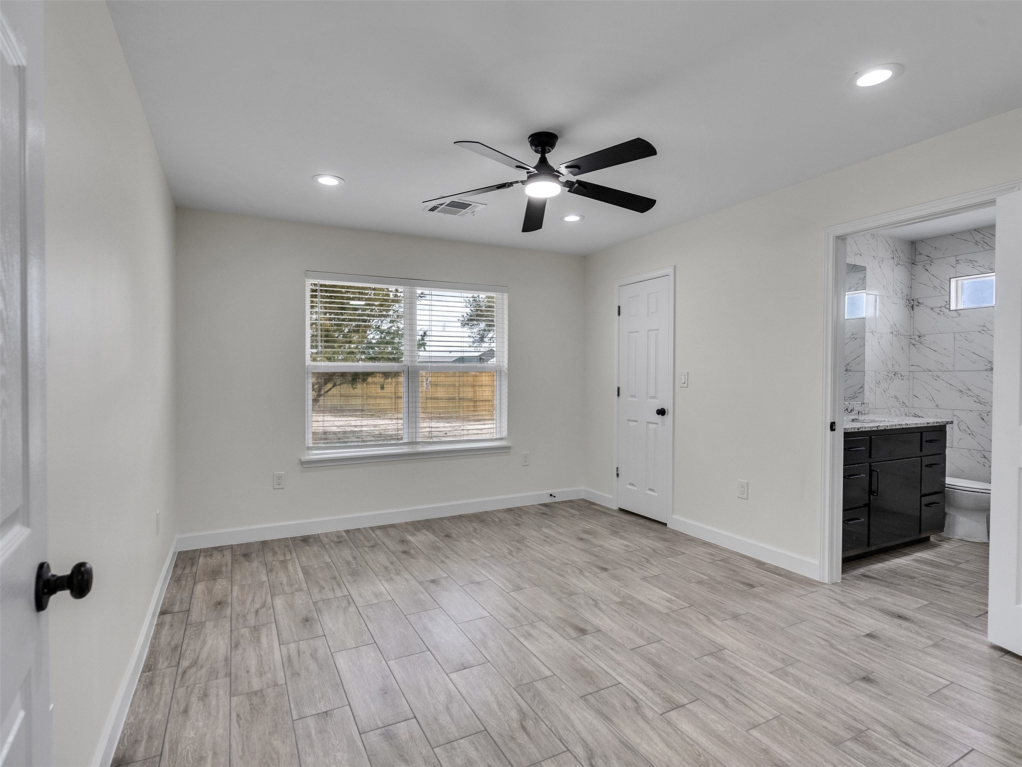 4835 County Road 380 Rosharon, TX 77583 - Photo 7 of 38 a view of an empty room with a window and wooden floor