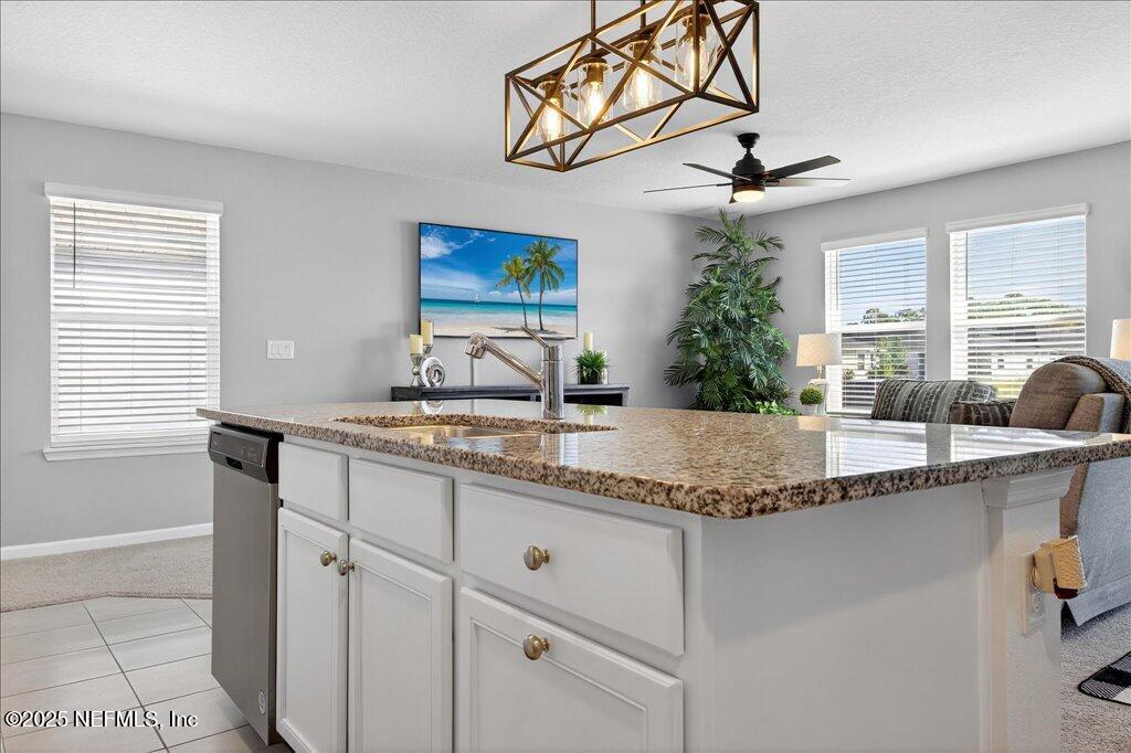 7 Windsor Place Palm Coast, FL 32164 - Photo 13 of 40 a kitchen with granite countertop a sink and a window
