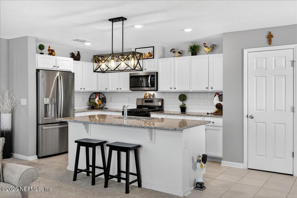 7 Windsor Place Palm Coast, FL 32164 - Photo 16 of 40 a kitchen with cabinets and stainless steel appliances