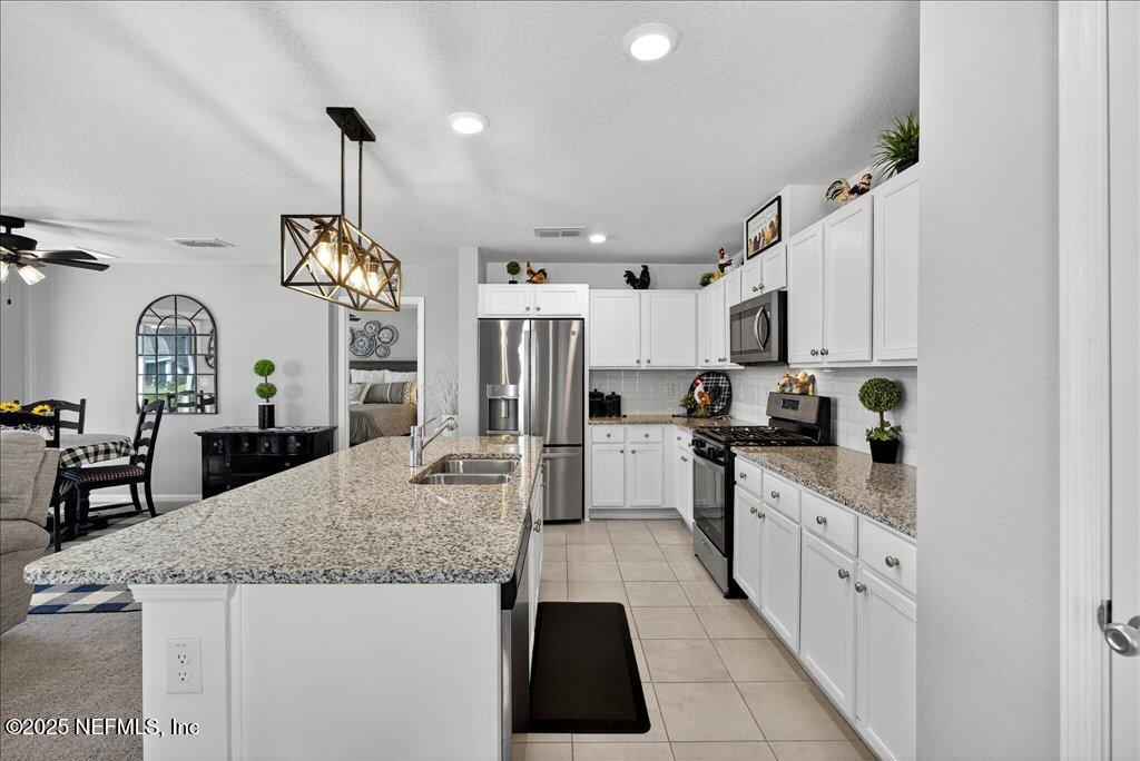 7 Windsor Place Palm Coast, FL 32164 - Photo 18 of 40 a kitchen with granite countertop white cabinets and refrigerator