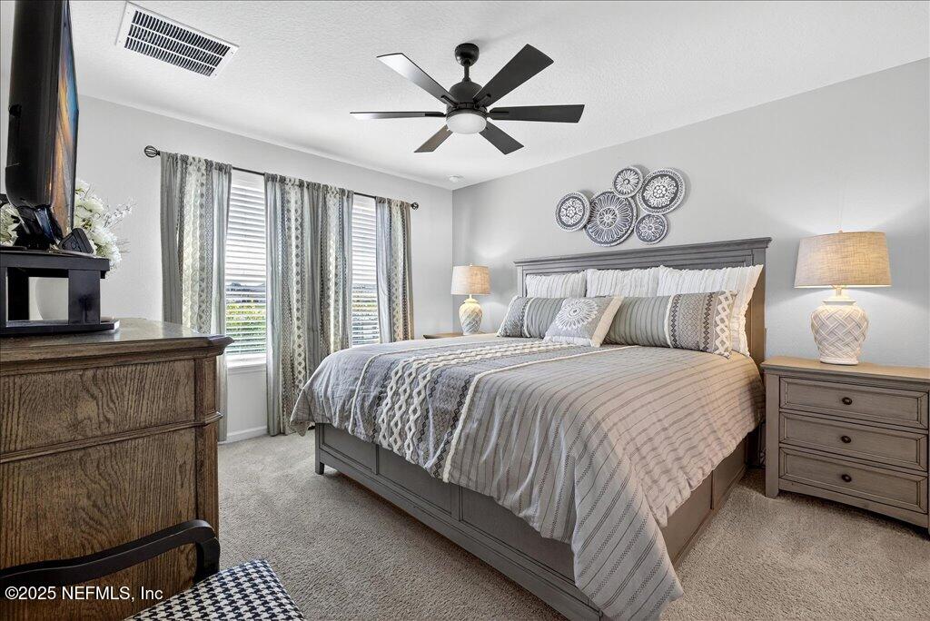 7 Windsor Place Palm Coast, FL 32164 - Photo 27 of 40 a bedroom with a bed and window