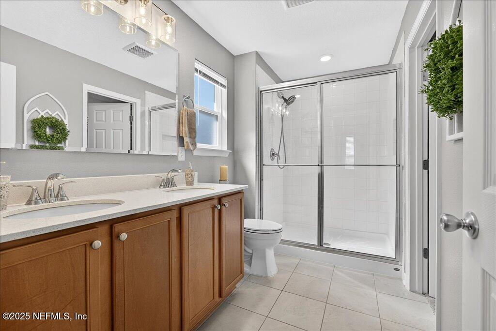 7 Windsor Place Palm Coast, FL 32164 - Photo 29 of 40 a bathroom with a sink a toilet and shower