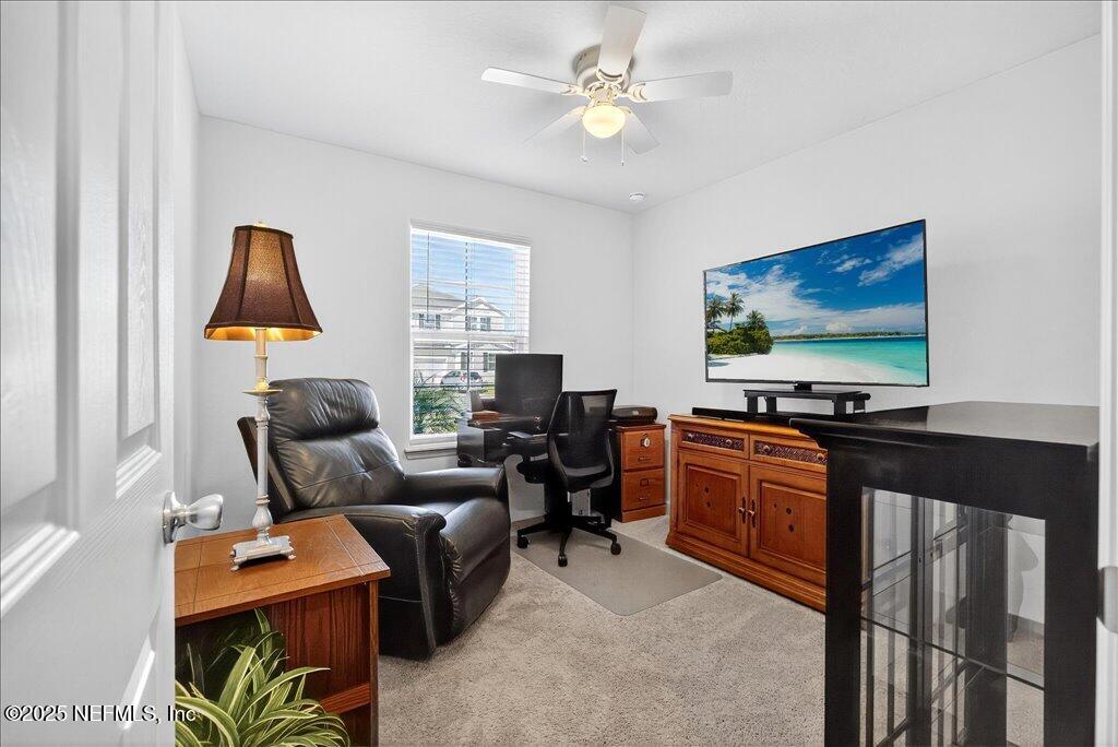 7 Windsor Place Palm Coast, FL 32164 - Photo 31 of 40 a living room with furniture and a flat screen tv