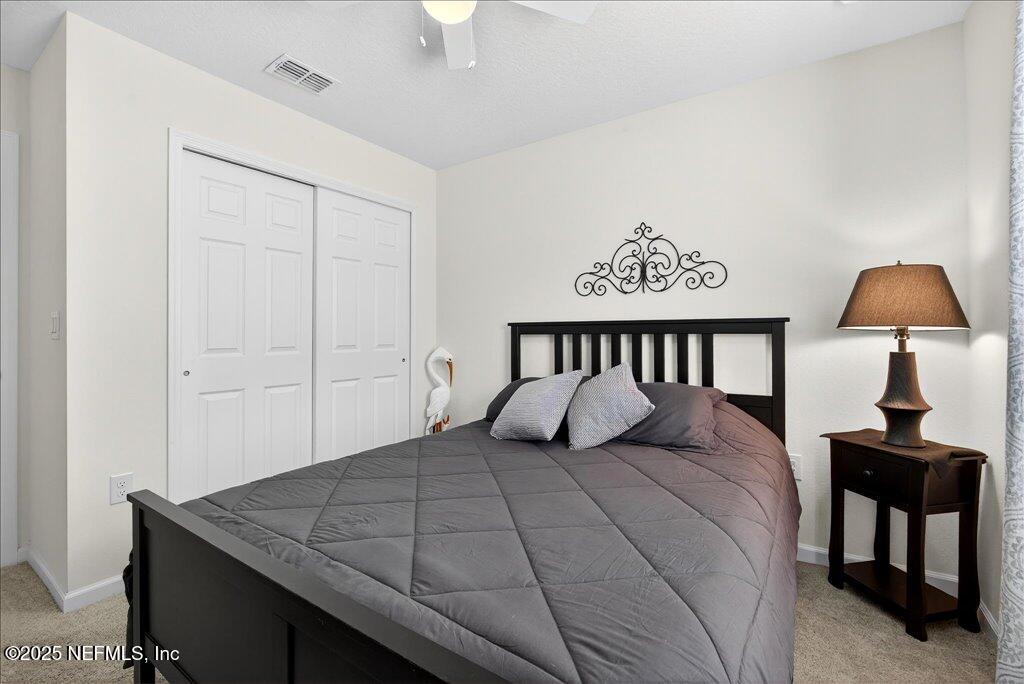 7 Windsor Place Palm Coast, FL 32164 - Photo 33 of 40 a bedroom with a bed and a table