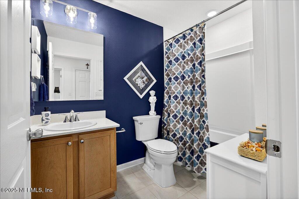 7 Windsor Place Palm Coast, FL 32164 - Photo 34 of 40 a bathroom with a sink a toilet and a mirror