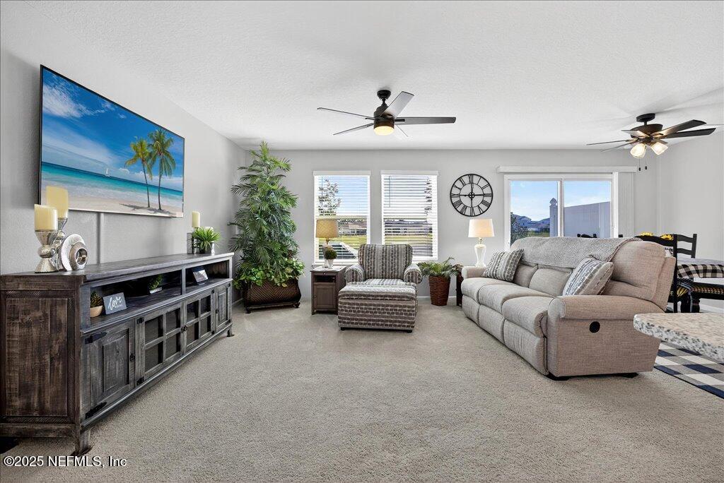 7 Windsor Place Palm Coast, FL 32164 - Photo 8 of 40 a living room with furniture and a large window
