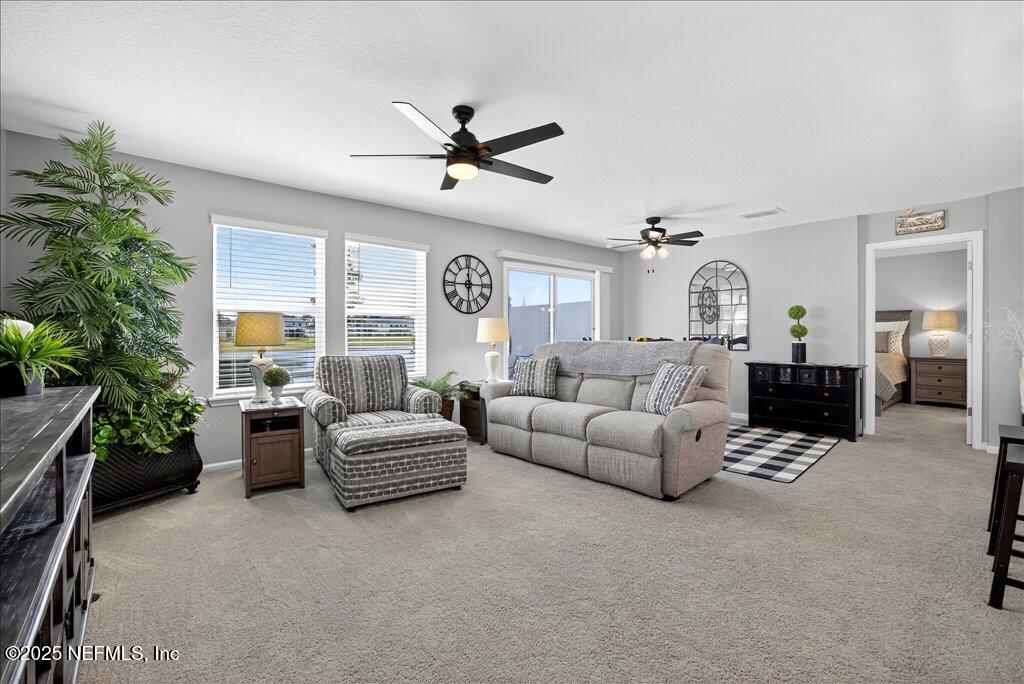 7 Windsor Place Palm Coast, FL 32164 - Photo 9 of 40 a living room with furniture and a large window