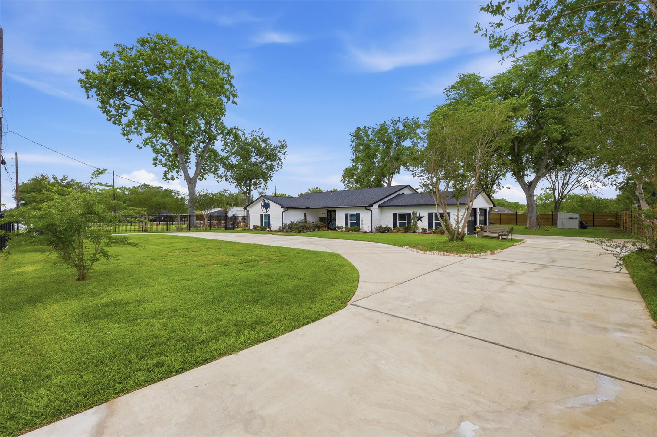5111 Brookside Road Pearland, TX 77581 - Photo 29 of 42 Additional exterior angle showcasing the gated entry, circular drive, and impressive one acre setting.