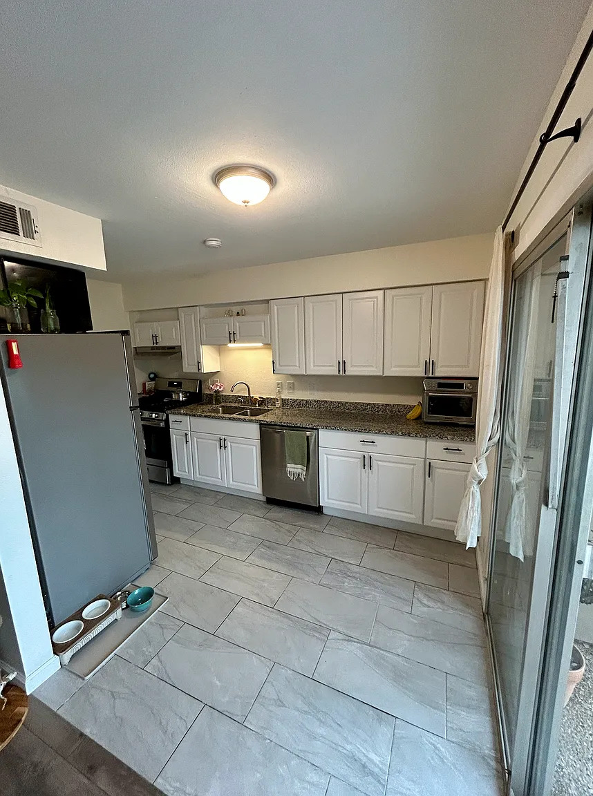 620 South 1st Street, Unit 106 Austin, TX 78704 - Photo 4 of 13 a kitchen with stainless steel appliances granite countertop a refrigerator sink and cabinets