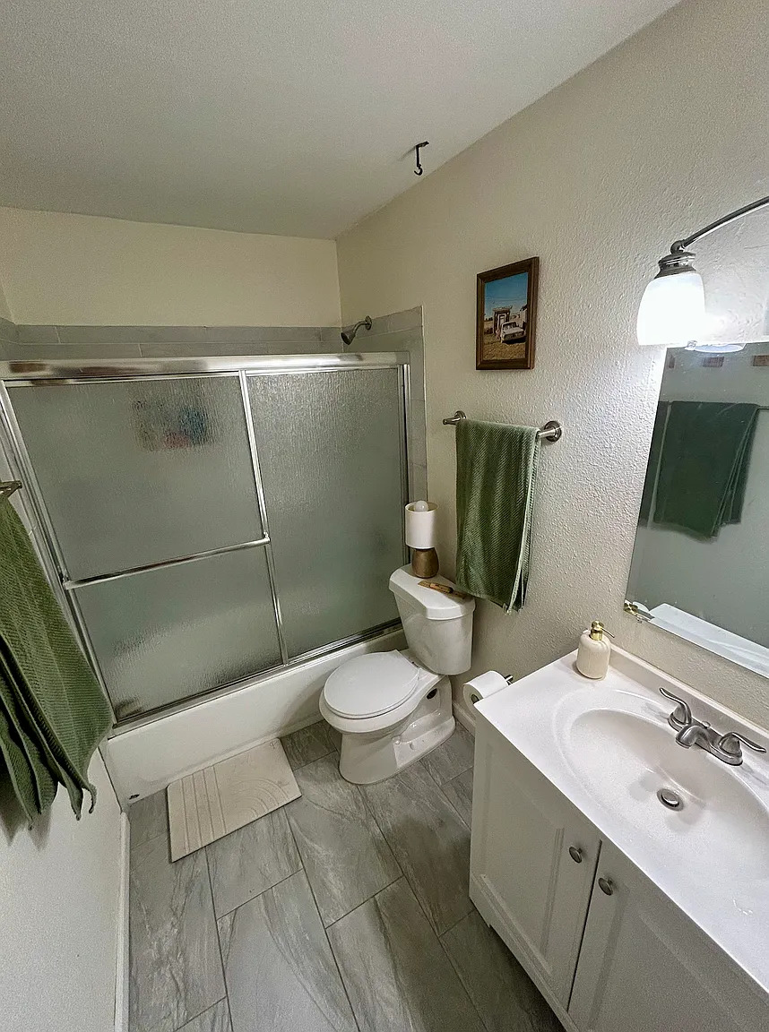 620 South 1st Street, Unit 106 Austin, TX 78704 - Photo 8 of 13 a bathroom with a sink toilet and shower