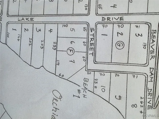 a green field with lots of trees in the background