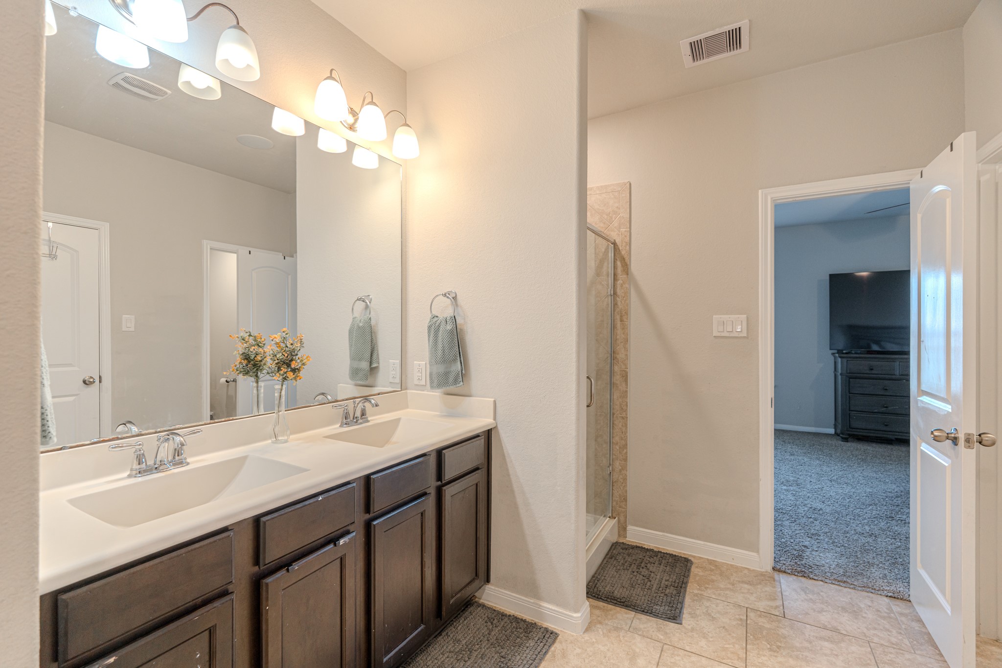 14207 Irvine Rnch Trail Conroe, TX 77384 - Photo 19 of 29 a bathroom with a double vanity sink a and a mirror