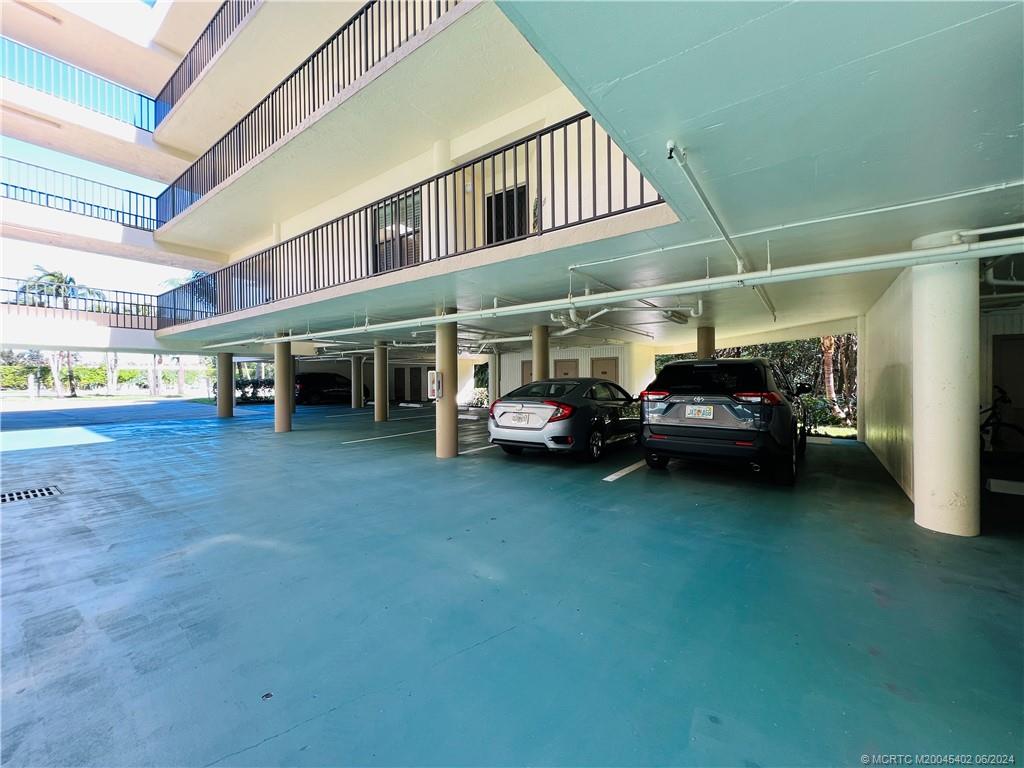 221 Northeast Plantation Road, Unit 215 Stuart, FL 34996 - Photo 66 of 83 a view of a car park in front of building