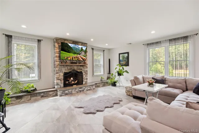 a living room with furniture fireplace and window