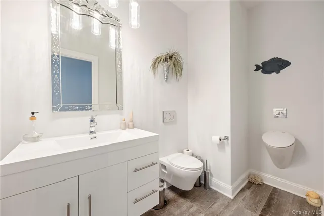 a spacious bathroom with a toilet sink and mirror