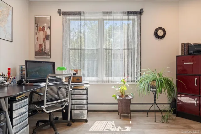 a workspace with furniture and a potted plant