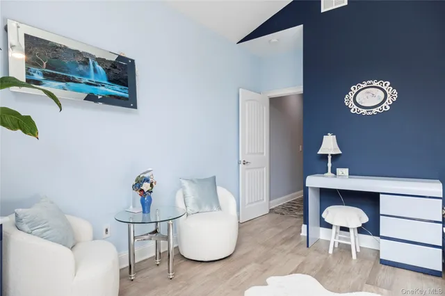 a dining room with furniture and a lamp