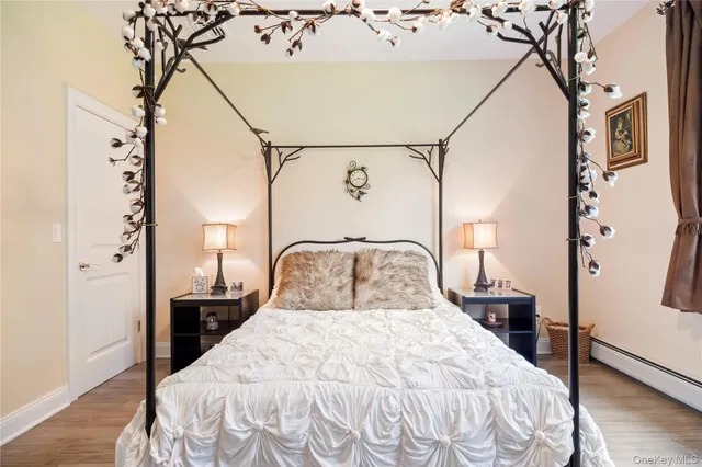 a bedroom with a bed and a potted plant