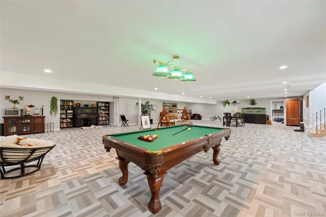 a living room with furniture and pool table