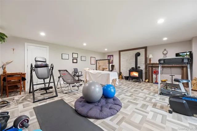 a living room with furniture a flat screen tv and kitchen view