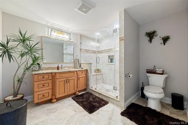a spacious bathroom with a granite countertop sink and a mirror