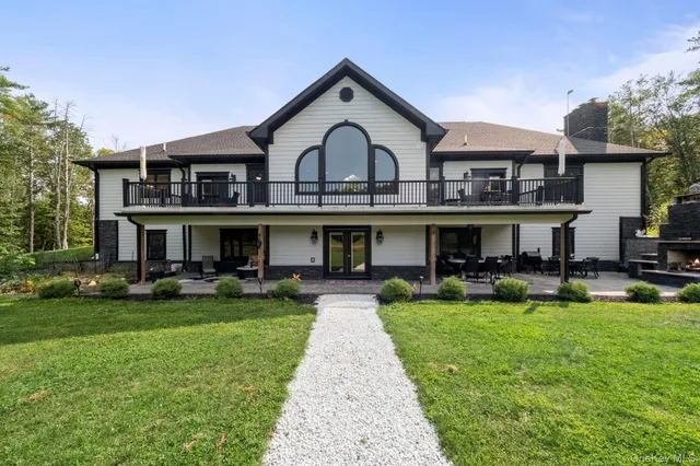 a front view of house with yard and outdoor seating