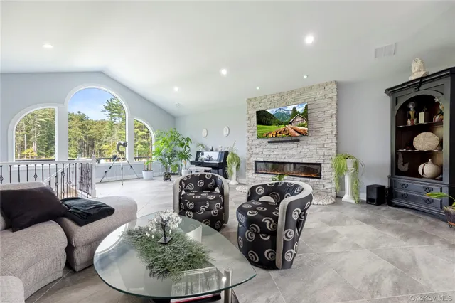 a living room with furniture fireplace and window