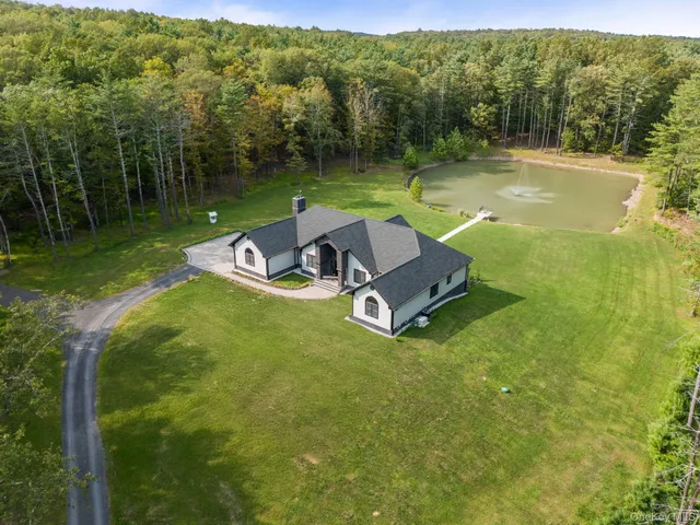 a view of a swimming pool with a yard