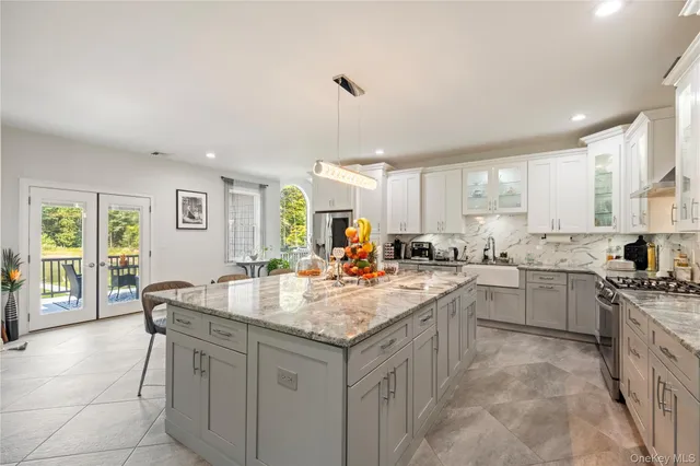 a kitchen with a stove sink and cabinets