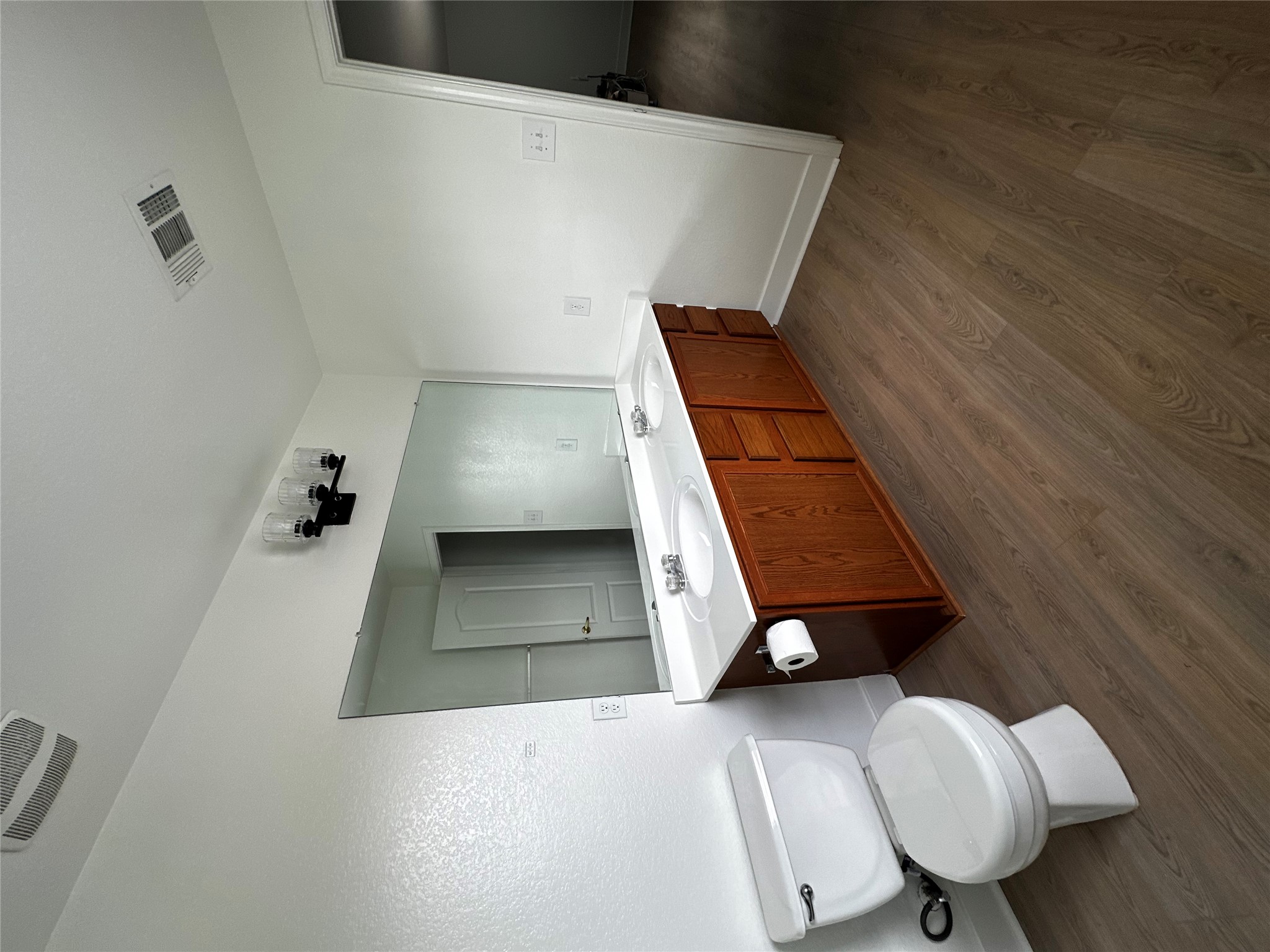 8016 Bannock Lane Austin, TX 78747 - Photo 16 of 32 a bathroom with a double vanity sink toilet and mirror