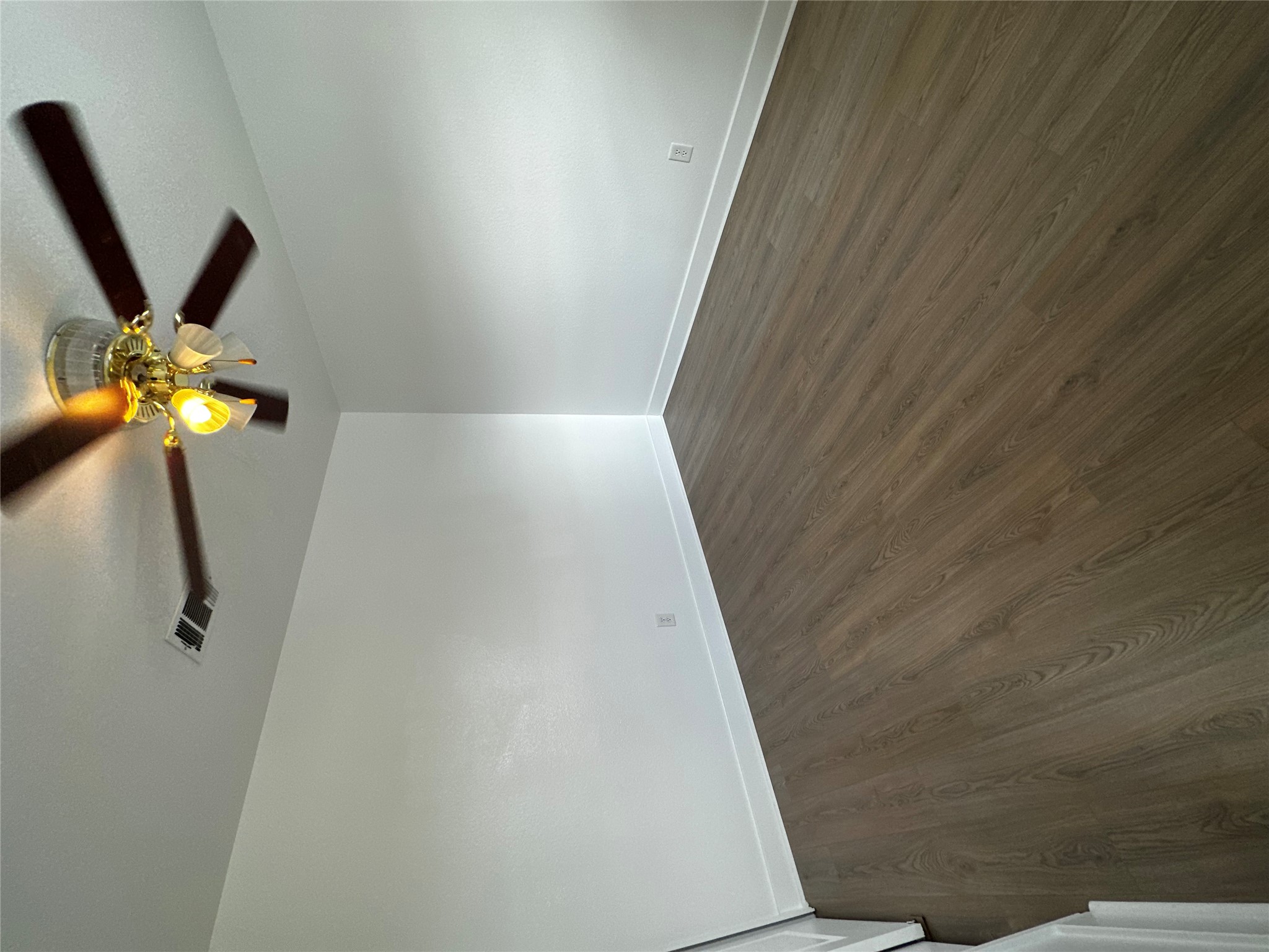 8016 Bannock Lane Austin, TX 78747 - Photo 24 of 32 an empty room with wooden floor fan and windows
