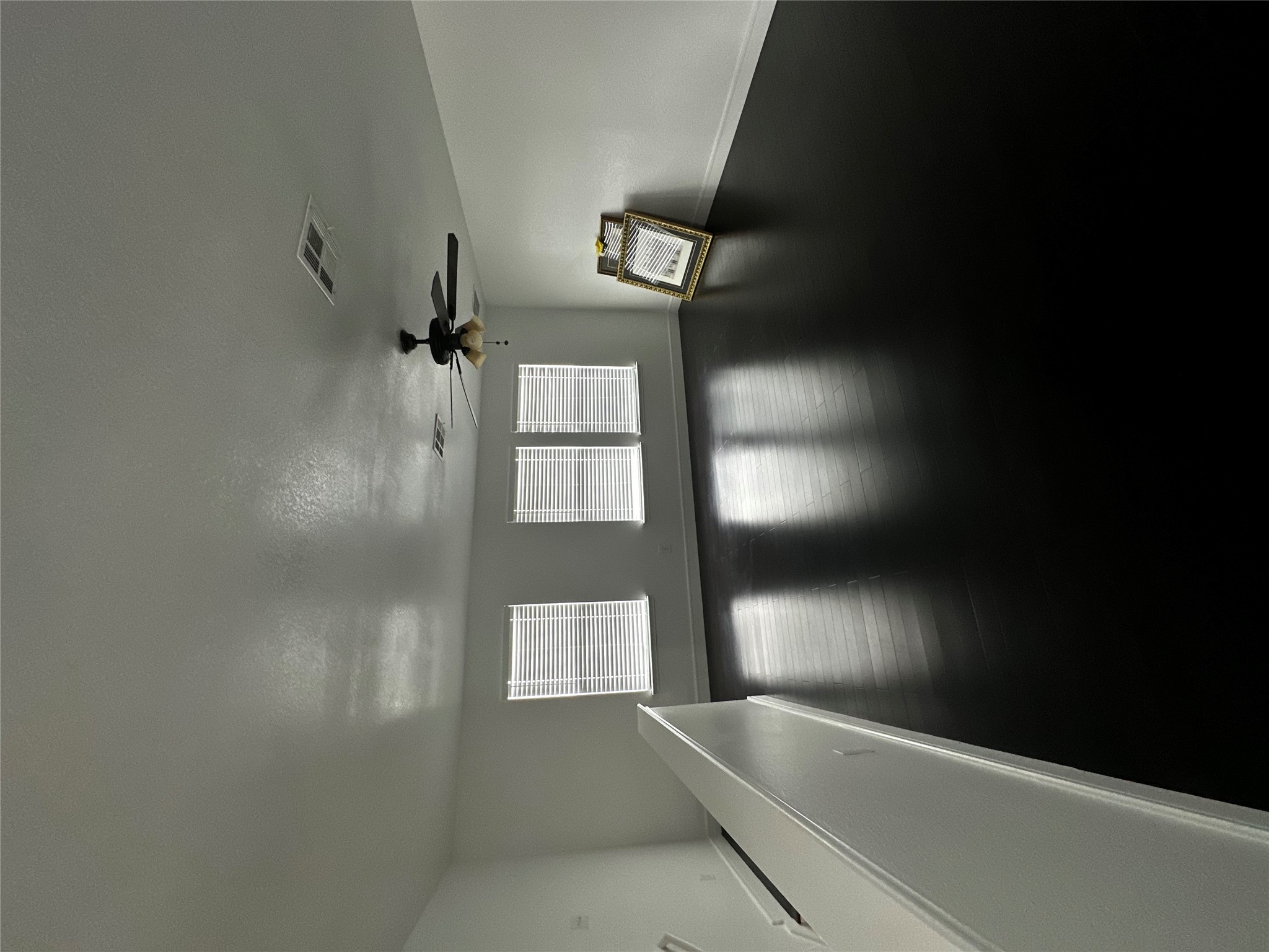 8016 Bannock Lane Austin, TX 78747 - Photo 26 of 32 a view of empty room with wooden floor and fan